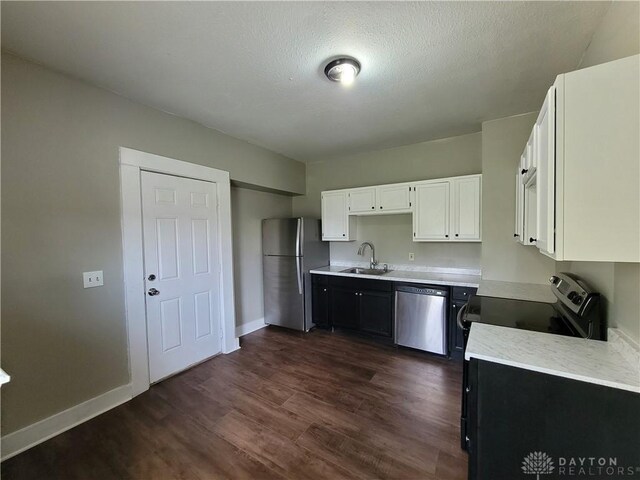 66 Barnett St Unit 64, Dayton, OH 45402 - kitchen featuring appliances with stainless steel finishes, a sink, light countertops, white cabinets, and dark wood-style floors