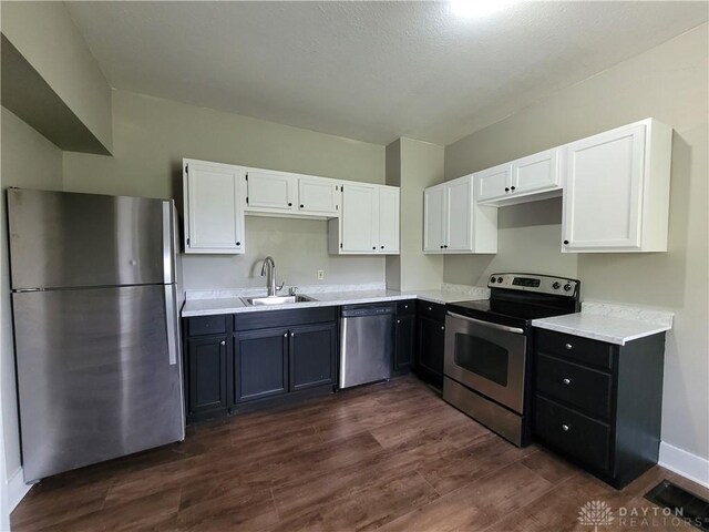 66 Barnett St Unit 64, Dayton, OH 45402 - kitchen with appliances with stainless steel finishes, white cabinetry, a sink, and light countertops