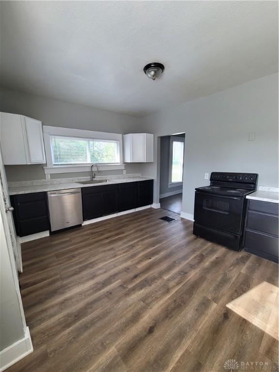 66 Barnett St Unit 64, Dayton, OH 45402 - kitchen featuring black electric range oven, dishwasher, a sink, light countertops, and white cabinetry