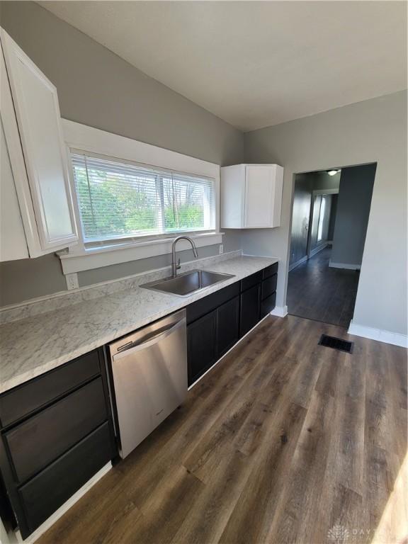 66 Barnett St Unit 64, Dayton, OH 45402 - kitchen with a sink, dishwasher, white cabinets, and plenty of natural light