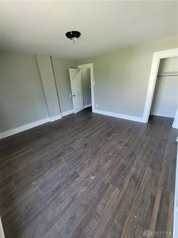 66 Barnett St Unit 64, Dayton, OH 45402 - unfurnished bedroom with dark wood-type flooring and baseboards