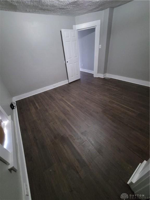 66 Barnett St Unit 64, Dayton, OH 45402 - spare room with dark wood finished floors and baseboards