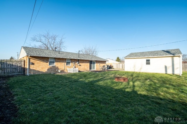 rear view of property with brick siding, fence, cooling unit, and a lawn