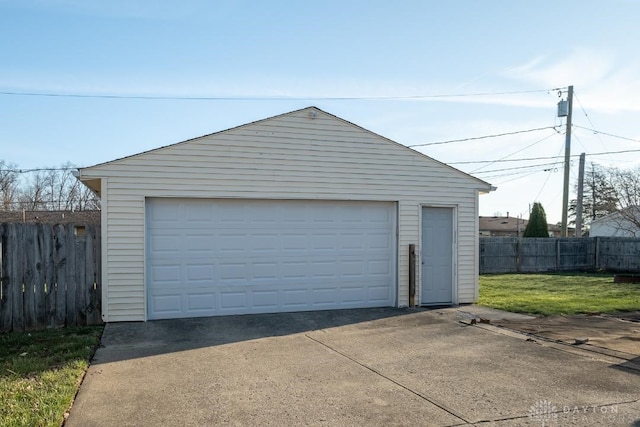 detached garage featuring fence