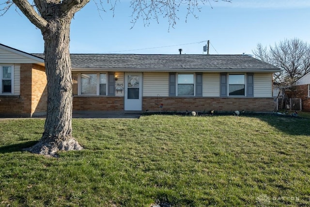 ranch-style home with brick siding and a front lawn