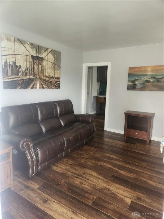 living room featuring baseboards and wood finished floors