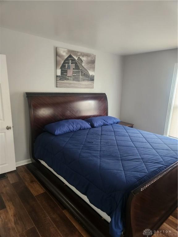 bedroom featuring wood finished floors and baseboards