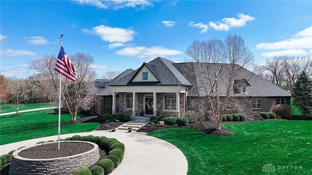 7177 Paul Ln, Liberty Twp, OH 45044 - view of front facade featuring a front yard, stone siding, and covered porch