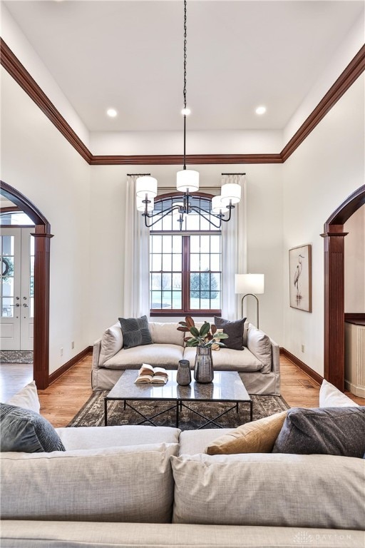 7177 Paul Ln, Liberty Twp, OH 45044 - living area with arched walkways, wood finished floors, a chandelier, and baseboards