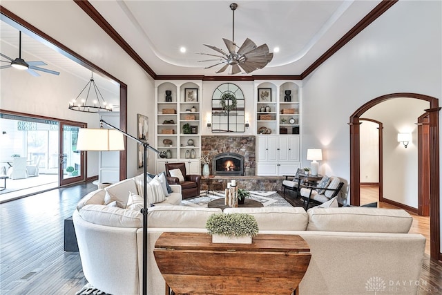 7177 Paul Ln, Liberty Twp, OH 45044 - living area featuring a ceiling fan, a stone fireplace, built in features, and wood finished floors