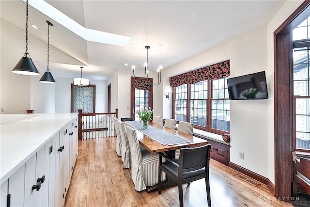 7177 Paul Ln, Liberty Twp, OH 45044 - dining room featuring visible vents, an inviting chandelier, light wood-style flooring, and plenty of natural light