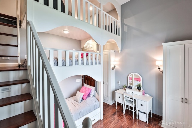 7177 Paul Ln, Liberty Twp, OH 45044 - bedroom with wood finished floors, baseboards, a notable chandelier, and a high ceiling