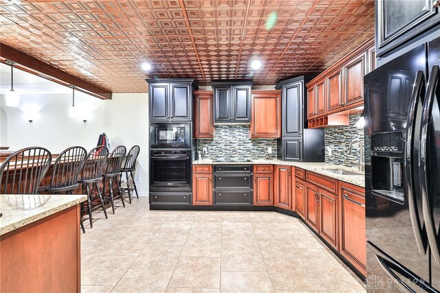 7177 Paul Ln, Liberty Twp, OH 45044 - kitchen with tasteful backsplash, light stone countertops, black appliances, an ornate ceiling, and a sink