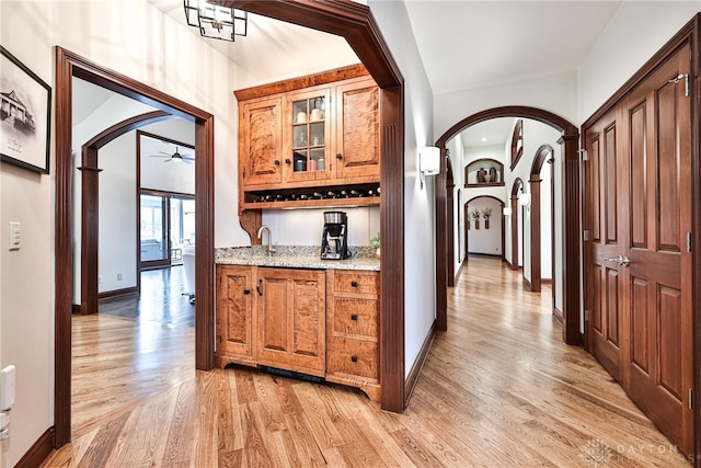 7177 Paul Ln, Liberty Twp, OH 45044 - hall featuring baseboards, light wood-type flooring, and arched walkways