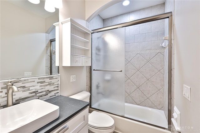 7177 Paul Ln, Liberty Twp, OH 45044 - bathroom featuring toilet, bath / shower combo with glass door, vanity, and tasteful backsplash