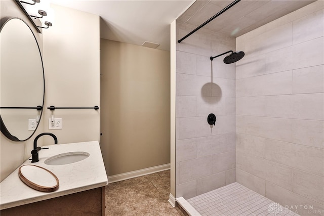 7177 Paul Ln, Liberty Twp, OH 45044 - bathroom with tile patterned flooring, tiled shower, vanity, and baseboards
