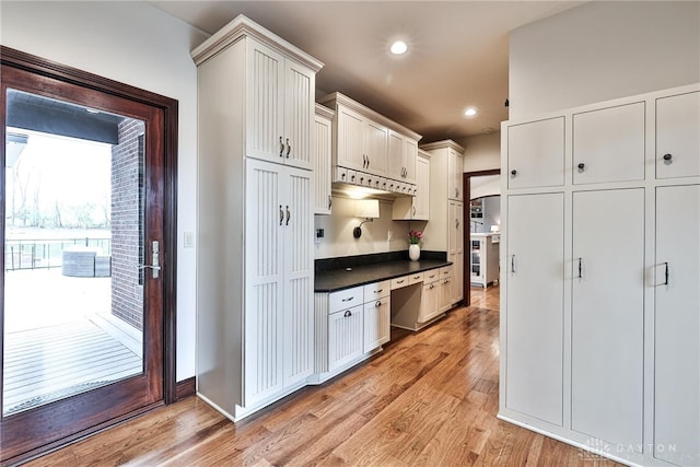 7177 Paul Ln, Liberty Twp, OH 45044 - kitchen featuring recessed lighting, dark countertops, light wood-style floors, and built in desk
