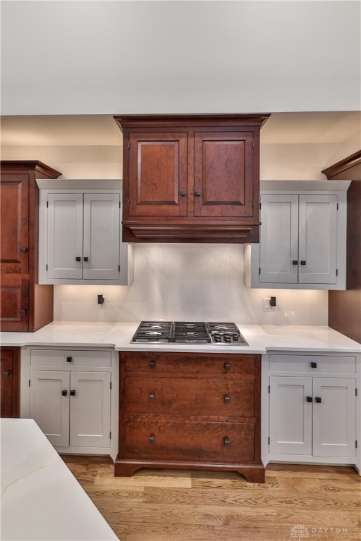 7177 Paul Ln, Liberty Twp, OH 45044 - kitchen with light wood-style floors, stainless steel gas stovetop, and light countertops