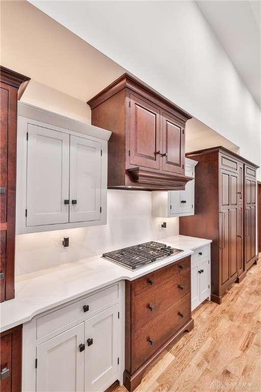 7177 Paul Ln, Liberty Twp, OH 45044 - kitchen with white cabinetry, light countertops, light wood-style floors, and stainless steel gas stovetop