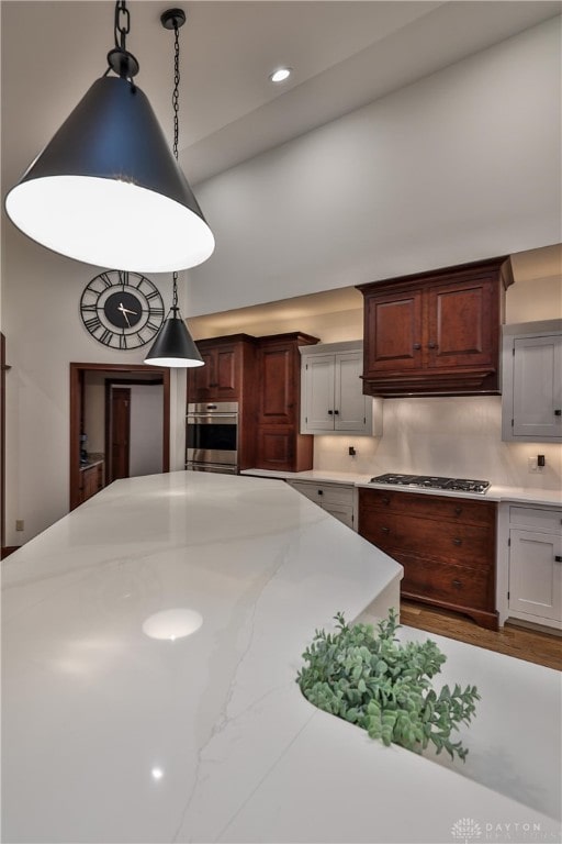 7177 Paul Ln, Liberty Twp, OH 45044 - kitchen with recessed lighting, decorative light fixtures, a towering ceiling, appliances with stainless steel finishes, and wood finished floors