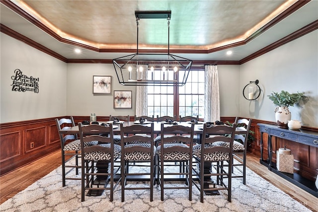 7177 Paul Ln, Liberty Twp, OH 45044 - dining room featuring an inviting chandelier, a raised ceiling, light wood-type flooring, and wainscoting