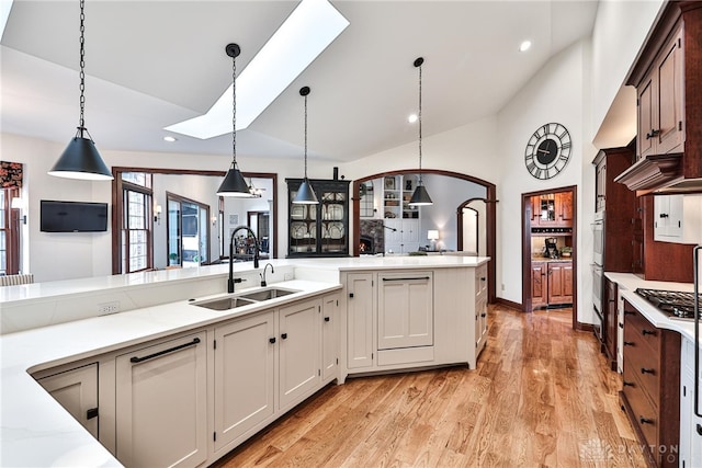 7177 Paul Ln, Liberty Twp, OH 45044 - kitchen featuring recessed lighting, a sink, light wood-type flooring, lofted ceiling with skylight, and pendant lighting