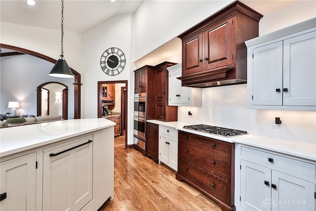 7177 Paul Ln, Liberty Twp, OH 45044 - kitchen with decorative light fixtures, stainless steel appliances, light wood-style floors, a warming drawer, and light countertops
