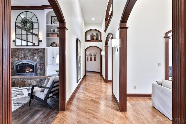 7177 Paul Ln, Liberty Twp, OH 45044 - hall featuring baseboards, light wood finished floors, and arched walkways