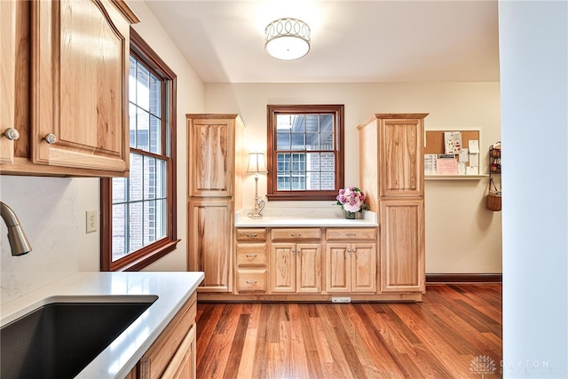 7177 Paul Ln, Liberty Twp, OH 45044 - kitchen featuring wood finished floors, light brown cabinets, light countertops, and a sink