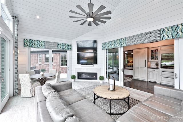 7177 Paul Ln, Liberty Twp, OH 45044 - living room with high vaulted ceiling, wood finished floors, ceiling fan, and a glass covered fireplace