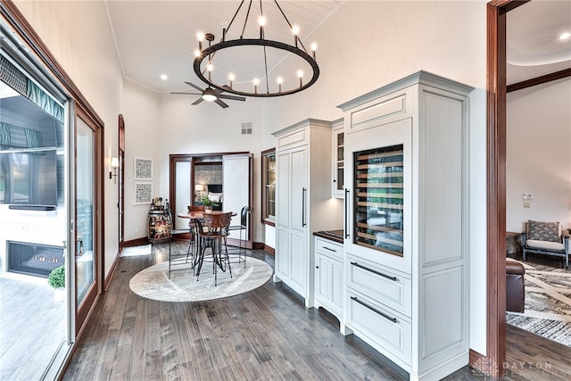 7177 Paul Ln, Liberty Twp, OH 45044 - dining area with a chandelier, visible vents, baseboards, dark wood-style flooring, and a high ceiling