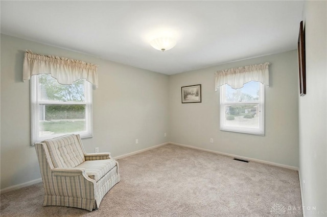 unfurnished room featuring visible vents, carpet flooring, a wealth of natural light, and baseboards