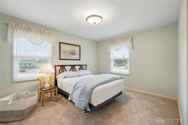 bedroom with baseboards, carpet floors, and multiple windows
