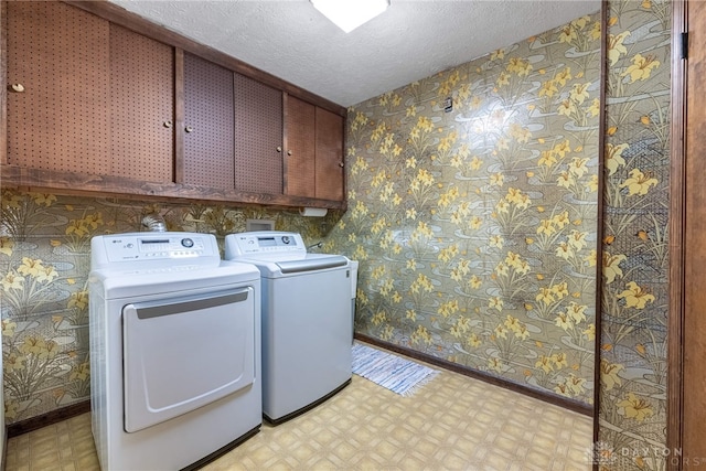 9168 Woodstream Ln, Washington Twp, OH 45458 - washroom featuring cabinet space, light floors, washer and dryer, wallpapered walls, and a textured ceiling