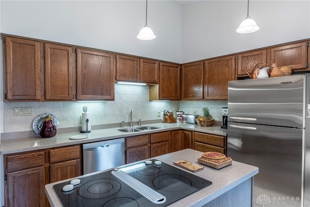 9168 Woodstream Ln, Washington Twp, OH 45458 - kitchen with appliances with stainless steel finishes, pendant lighting, decorative backsplash, and light countertops