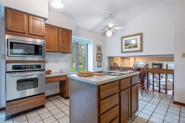 9168 Woodstream Ln, Washington Twp, OH 45458 - kitchen featuring stainless steel appliances, light tile patterned flooring, light countertops, and brown cabinetry