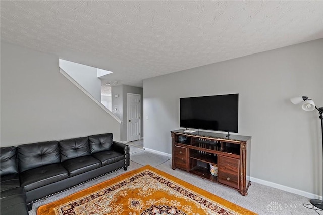 living room featuring baseboards, stairs, a textured ceiling, and light colored carpet