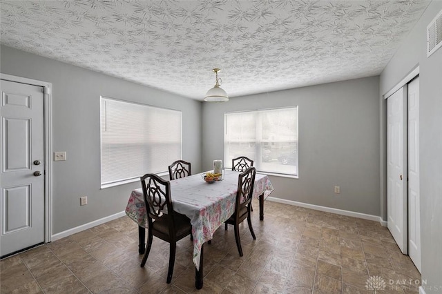 dining room featuring visible vents and baseboards