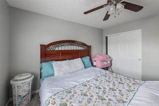 bedroom with a closet, a ceiling fan, carpet floors, and baseboards