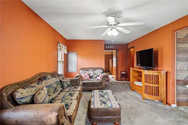 living room featuring ceiling fan and carpet