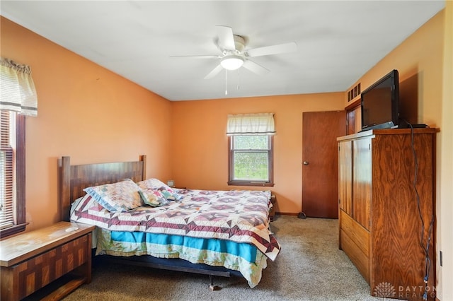 bedroom featuring visible vents, light carpet, and ceiling fan