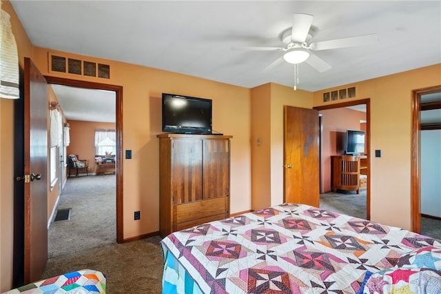 carpeted bedroom featuring baseboards, visible vents, and ceiling fan