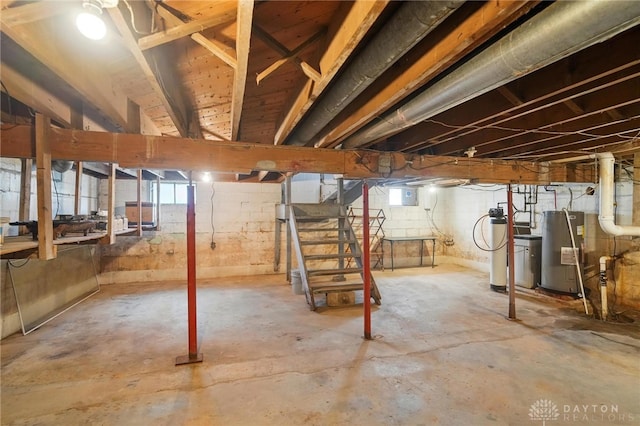 basement featuring water heater and stairs