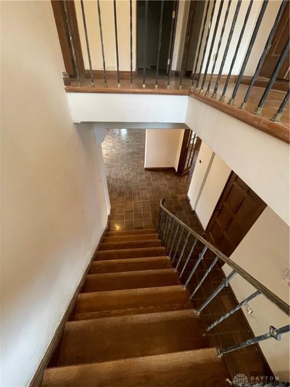 staircase featuring wood finished floors