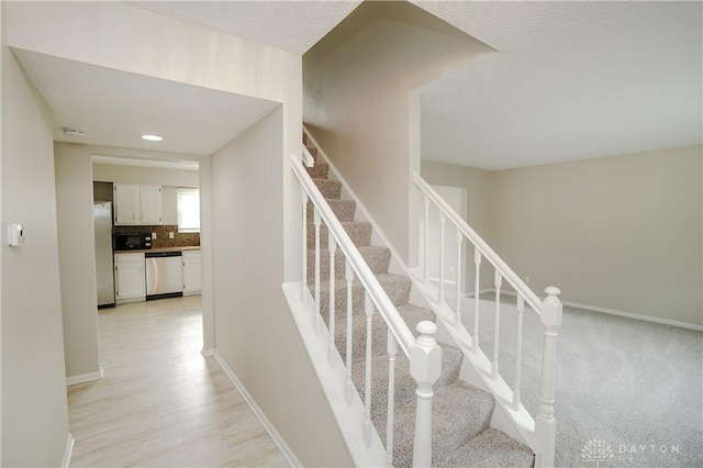 8500 Crestmont Dr, West Chester, OH 45069 - staircase with baseboards and wood finished floors