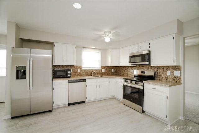 8500 Crestmont Dr, West Chester, OH 45069 - kitchen with appliances with stainless steel finishes, white cabinetry, decorative backsplash, and light countertops