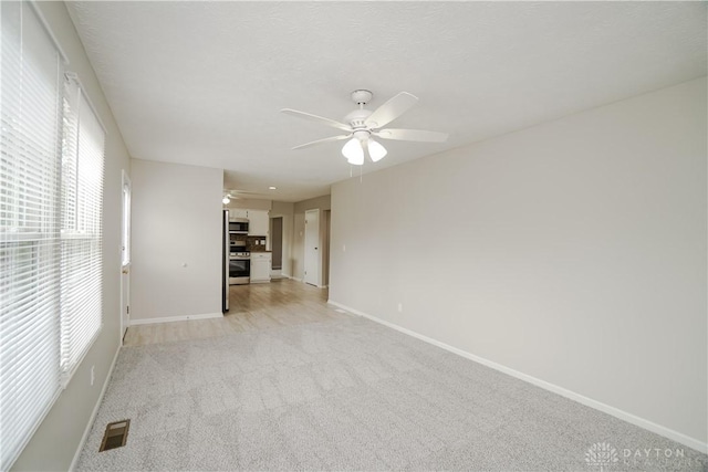 8500 Crestmont Dr, West Chester, OH 45069 - unfurnished living room featuring ceiling fan and light colored carpet