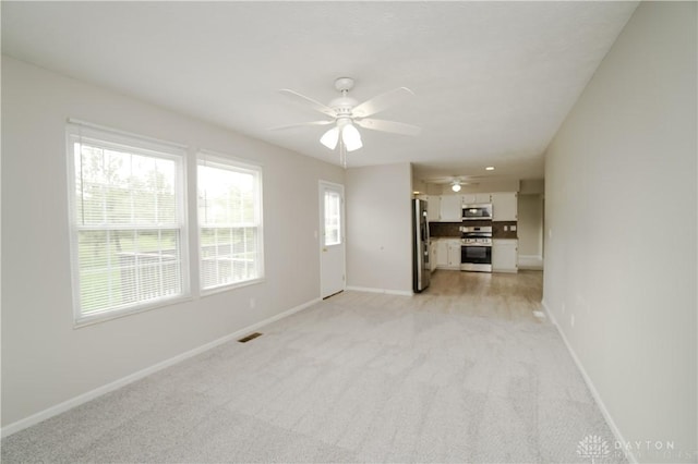 8500 Crestmont Dr, West Chester, OH 45069 - unfurnished living room featuring a ceiling fan and light colored carpet