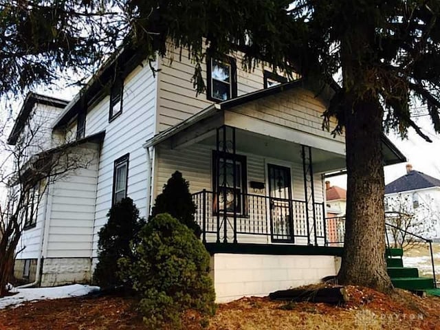 14 N Freeman St, Springfield, OH 45503 - view of snowy exterior with a porch