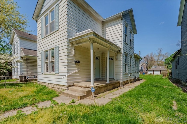 view of front of house with fence and a front yard